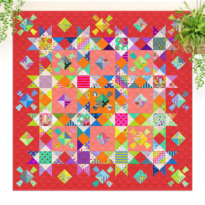 Colorful quilt with geometric patterns on a red background, with plants in the corners.